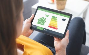 Energy efficiency mobile app on screen. Ecology, eco house concept Energy efficiency mobile app on screen. Ecology, eco house concept